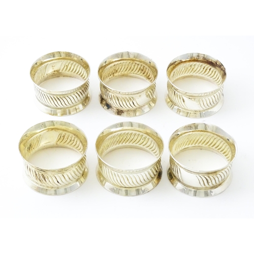 377 - A cased set of six silver plate napkin rings. Case approx. 5 1/2