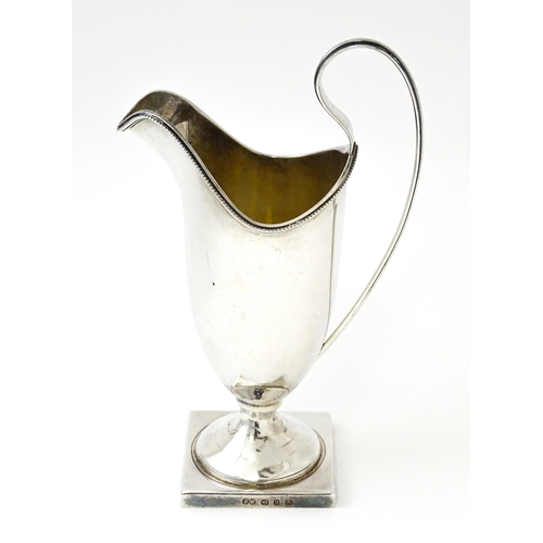 380 - A Victorian silver helmet cream jug, hallmarked Birmingham 1894, maker John Edward Wilmot. Approx. 6... 