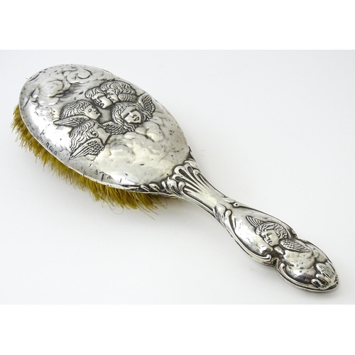 388 - A silver hairbrush with embossed angel decoration hallmarked Birmingham 1904, maker Henry Matthews. ... 