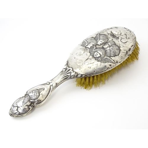 388 - A silver hairbrush with embossed angel decoration hallmarked Birmingham 1904, maker Henry Matthews. ... 