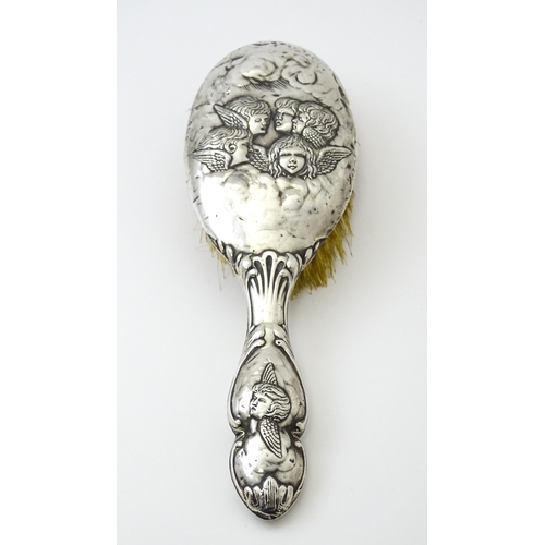 388 - A silver hairbrush with embossed angel decoration hallmarked Birmingham 1904, maker Henry Matthews. ... 