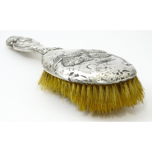 388 - A silver hairbrush with embossed angel decoration hallmarked Birmingham 1904, maker Henry Matthews. ... 