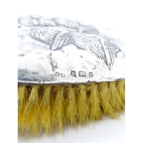 388 - A silver hairbrush with embossed angel decoration hallmarked Birmingham 1904, maker Henry Matthews. ... 