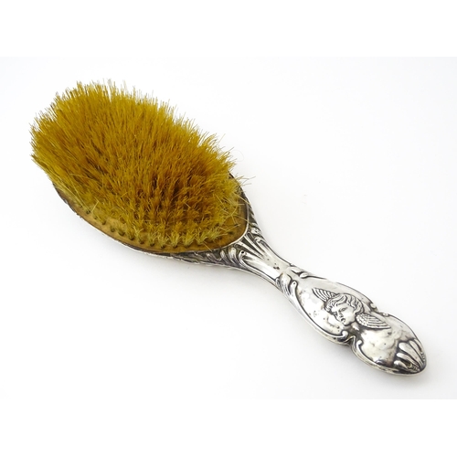 388 - A silver hairbrush with embossed angel decoration hallmarked Birmingham 1904, maker Henry Matthews. ... 