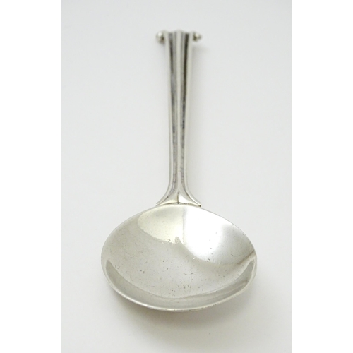 389 - Leslie G Durbin: A modern silver spoon with reeded handle and scroll finial, rat tail, and hammered ... 