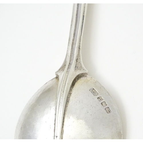 389 - Leslie G Durbin: A modern silver spoon with reeded handle and scroll finial, rat tail, and hammered ... 