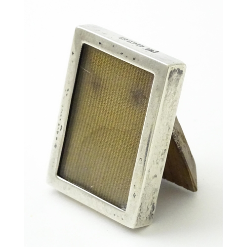 391 - A miniature easel back photograph frame with silver surround hallmarked Birmingham 1917, maker Lawre... 