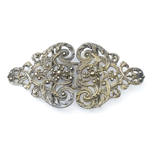 395 - A silver two sectional nurse's buckle with acanthus scroll and floral detail, hallmarked London 1975... 