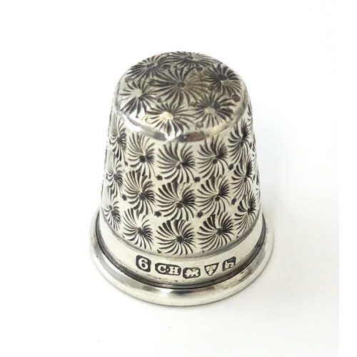 453 - A silver thimble hallmarked Chester 1919, maker Charles Horner. Together with a Continental silver t... 