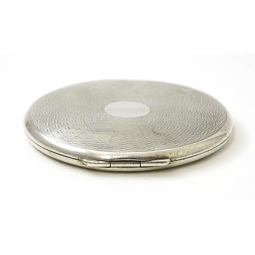 455 - An Art Deco silver compact with engine turned decoration hallmarked Birmingham 1940, maker Crisford ... 