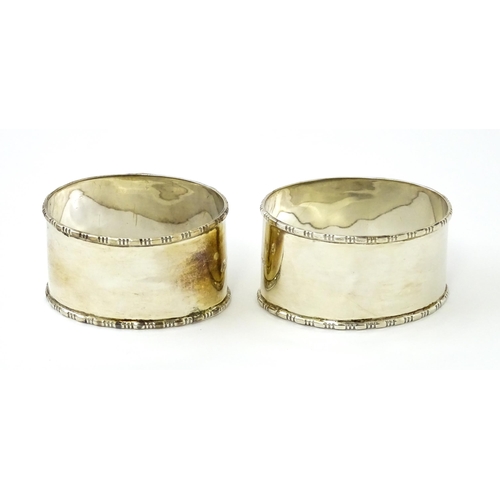 462 - A cased pair of silver napkin rings of oval form, hallmarked Birmingham 1938 maker Adie Brothers Ltd... 