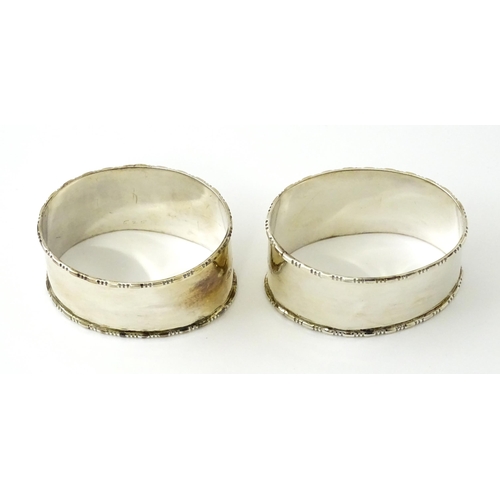 462 - A cased pair of silver napkin rings of oval form, hallmarked Birmingham 1938 maker Adie Brothers Ltd... 