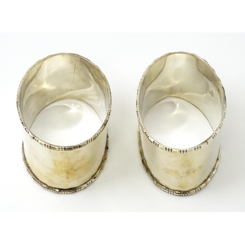 462 - A cased pair of silver napkin rings of oval form, hallmarked Birmingham 1938 maker Adie Brothers Ltd... 