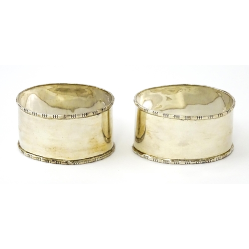 462 - A cased pair of silver napkin rings of oval form, hallmarked Birmingham 1938 maker Adie Brothers Ltd... 