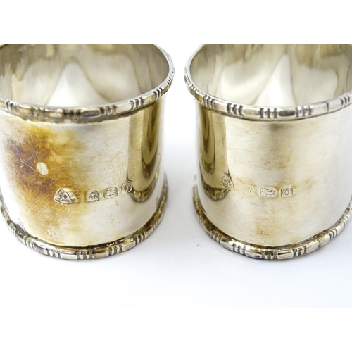 462 - A cased pair of silver napkin rings of oval form, hallmarked Birmingham 1938 maker Adie Brothers Ltd... 