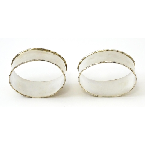 462 - A cased pair of silver napkin rings of oval form, hallmarked Birmingham 1938 maker Adie Brothers Ltd... 