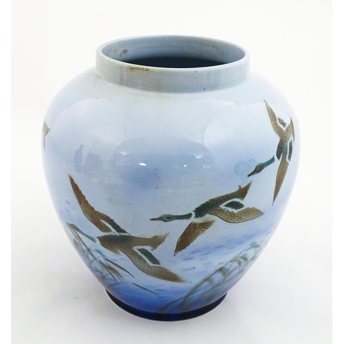 172 - A Falcon Ware vase decorated in the Misty Morn pattern depicting ducks in flight. Impressed Chang No... 