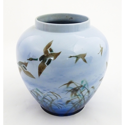 172 - A Falcon Ware vase decorated in the Misty Morn pattern depicting ducks in flight. Impressed Chang No... 
