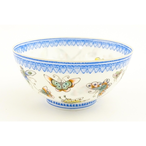 48 - Four Chinese items to include a tea bowl decorated with butterflies, a saucer with hand painted flor... 