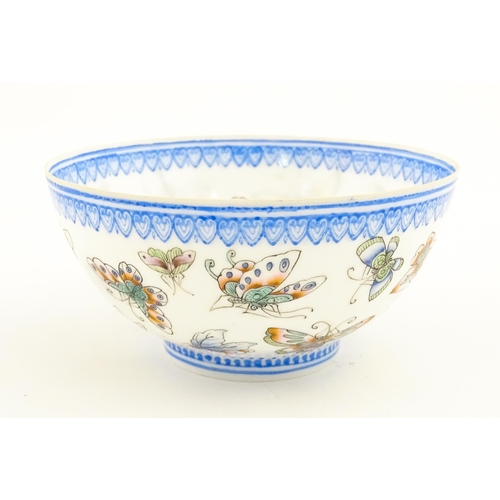 48 - Four Chinese items to include a tea bowl decorated with butterflies, a saucer with hand painted flor... 