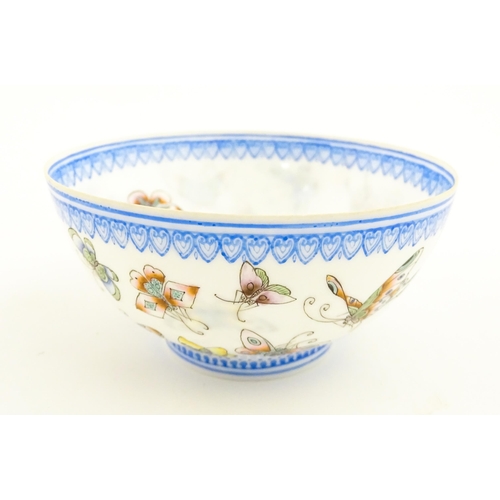 48 - Four Chinese items to include a tea bowl decorated with butterflies, a saucer with hand painted flor... 