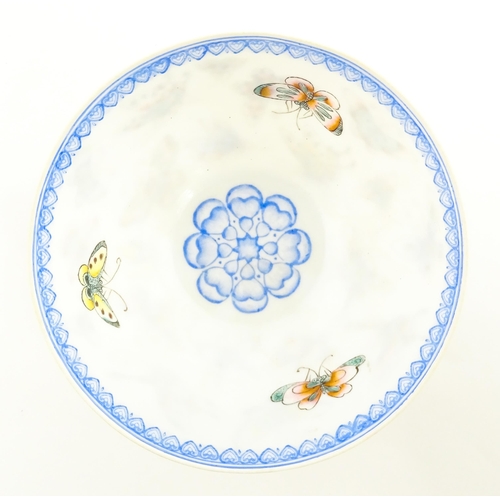 48 - Four Chinese items to include a tea bowl decorated with butterflies, a saucer with hand painted flor... 