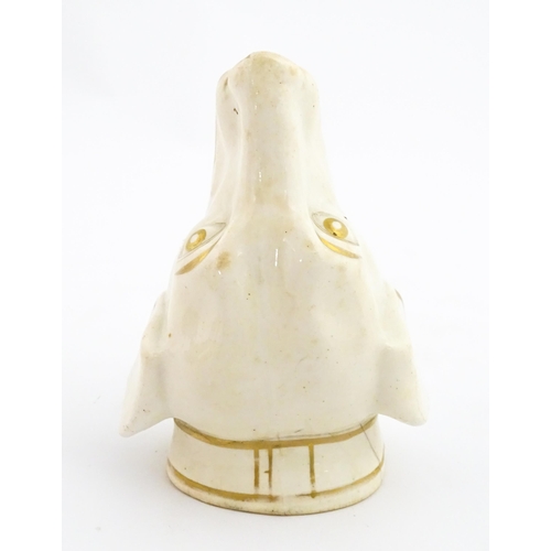 53 - A 19thC creamware stirrup cup of dog / hound head form with gilt detail. Approx. 4 3/4