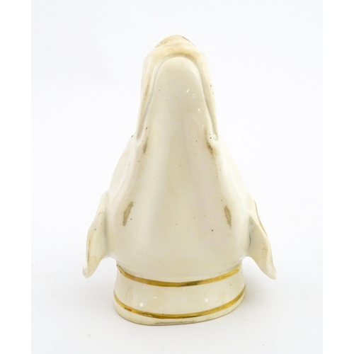 53 - A 19thC creamware stirrup cup of dog / hound head form with gilt detail. Approx. 4 3/4