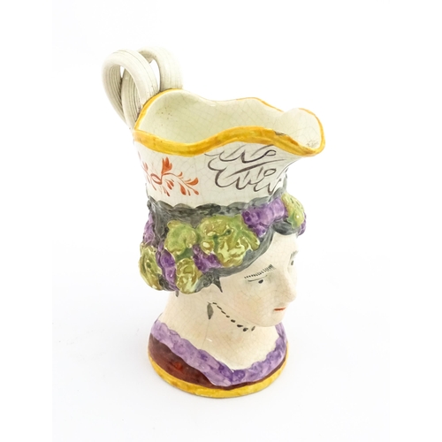 54 - A 19thC creamware mask jug depicting Princess Charlotte of Wales, made to commemorate her death in 1... 