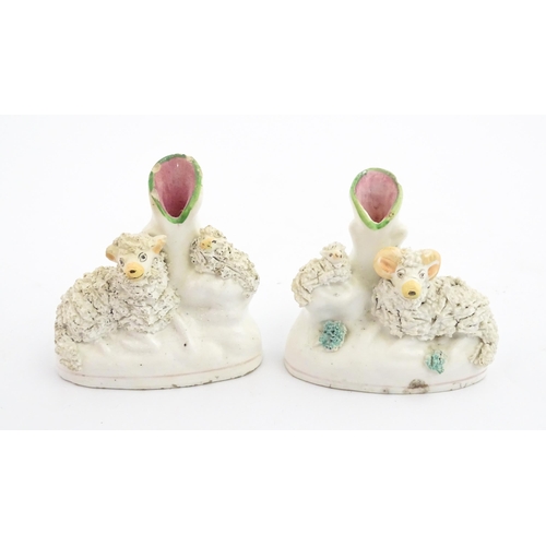 59 - A pair of Victorian Staffordshire pottery bud vases with sheep and lamb detail. Approx. 3 3/4