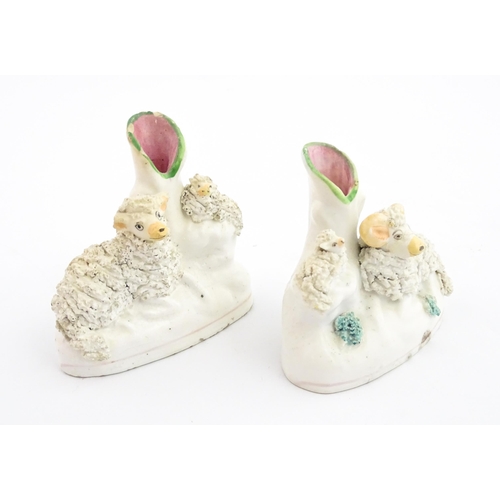 59 - A pair of Victorian Staffordshire pottery bud vases with sheep and lamb detail. Approx. 3 3/4