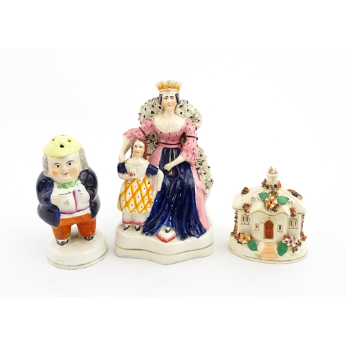 61 - Three items of Staffordshire pottery to include a figural Toby pepper pot, Queen Victorian and daugh... 