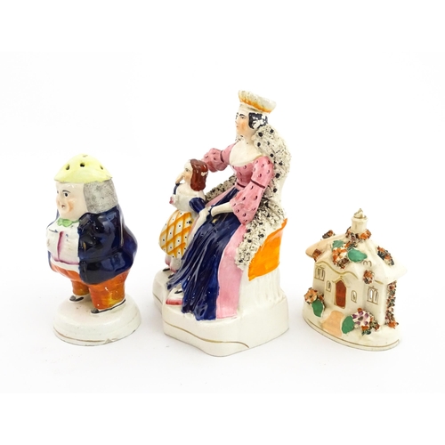 61 - Three items of Staffordshire pottery to include a figural Toby pepper pot, Queen Victorian and daugh... 