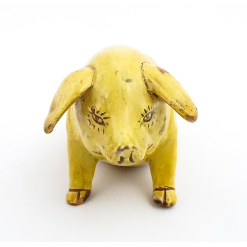 96 - A Welsh Ewenny pottery model of a seated pig with a yellow glaze. Signed under E. Jenkins Ewenny. Ap... 