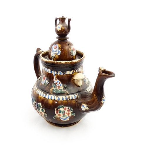 220 - A large 19thC Measham bargeware teapot bearing a plaque for James Puckey Polperro 1827, decorated wi... 