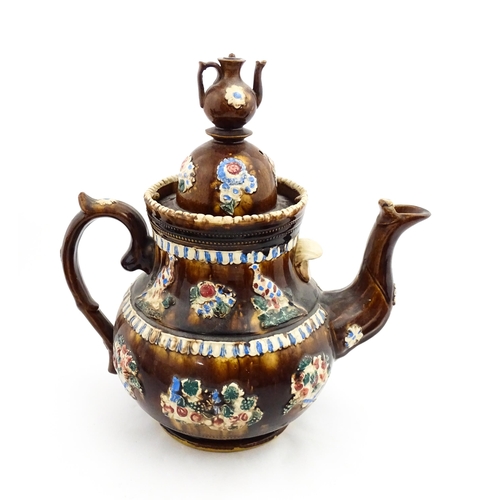 220 - A large 19thC Measham bargeware teapot bearing a plaque for James Puckey Polperro 1827, decorated wi... 