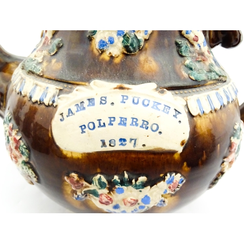 220 - A large 19thC Measham bargeware teapot bearing a plaque for James Puckey Polperro 1827, decorated wi... 