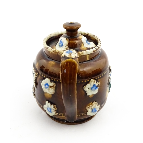 221 - A small Victorian Measham bargeware teapot bearing the motto Forget Me Not, with applied flower deta... 