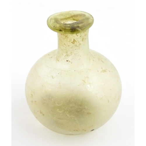 262 - A Roman glass flask with globular body and folded rim. Approx. 2 1/4