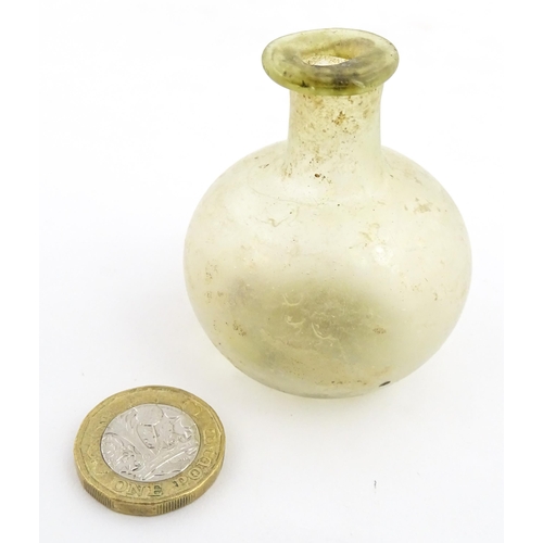 262 - A Roman glass flask with globular body and folded rim. Approx. 2 1/4