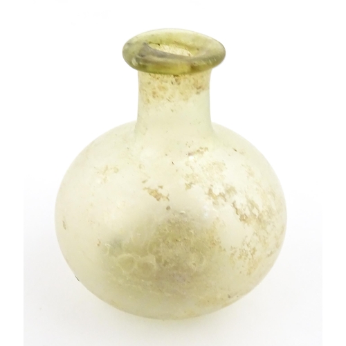 262 - A Roman glass flask with globular body and folded rim. Approx. 2 1/4