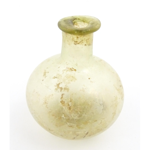 262 - A Roman glass flask with globular body and folded rim. Approx. 2 1/4