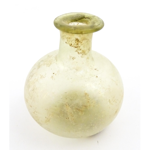 262 - A Roman glass flask with globular body and folded rim. Approx. 2 1/4