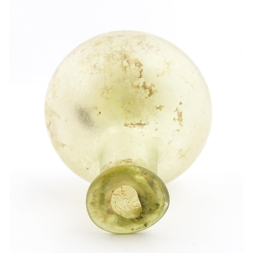 262 - A Roman glass flask with globular body and folded rim. Approx. 2 1/4