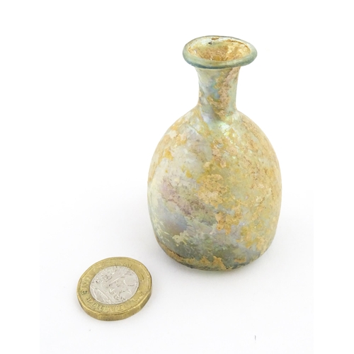 263 - A Roman glass flask with flared rim. Approx. 2 3/4