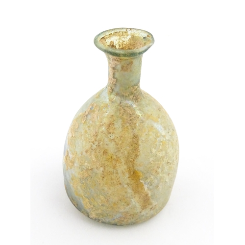 263 - A Roman glass flask with flared rim. Approx. 2 3/4