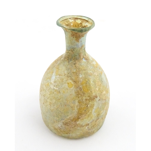 263 - A Roman glass flask with flared rim. Approx. 2 3/4