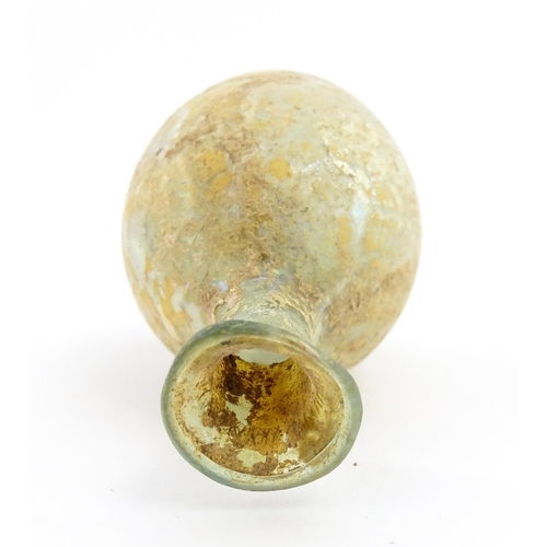 263 - A Roman glass flask with flared rim. Approx. 2 3/4