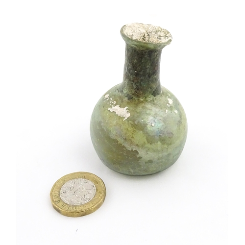 264 - A Roman glass flask with spherical body and cylindrical neck. Approx. 2 1/2