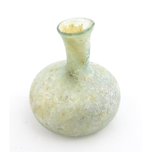 265 - A Roman glass flask with globular body and flared rim. Approx. 2 1/2